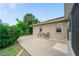 Backyard patio with chairs and a well-maintained exterior at 1299 Tripoli, North Port, FL 34286
