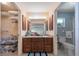 A dual-access bathroom with wooden vanity, and a walk-in closet provides convenience and ample storage at 1299 Tripoli, North Port, FL 34286