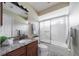 Well-lit bathroom with granite countertop, ample cabinet space, and shower-tub combination at 1299 Tripoli, North Port, FL 34286