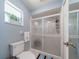 Light and airy bathroom featuring a glass-enclosed shower with decorative accents and neutral decor at 1299 Tripoli, North Port, FL 34286