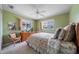 Cozy bedroom features two windows, a ceiling fan, and traditional-style furniture, creating a tranquil retreat at 1299 Tripoli, North Port, FL 34286