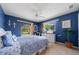 Blue bedroom featuring natural light from 2 windows, ceiling fan and a coastal themed decor at 1299 Tripoli, North Port, FL 34286