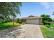 Charming single-story home with a well-manicured lawn and a two-car garage, offering curb appeal at 1299 Tripoli, North Port, FL 34286