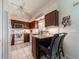 Charming kitchen features dark wood cabinetry, granite countertops, and a breakfast bar with seating at 1299 Tripoli, North Port, FL 34286