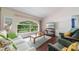 Comfortable living room with a large window offering serene views of lush landscaping at 1299 Tripoli, North Port, FL 34286