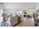 Bright living room with tile flooring, comfortable seating, and natural light, seamlessly connecting to the dining area at 1299 Tripoli, North Port, FL 34286