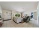 Inviting living room with tile floors, comfortable seating, and a bright front entry at 1299 Tripoli, North Port, FL 34286