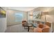 Cozy sitting area features soft peach chairs, a small round table, and a display shelf with woven baskets at 13113 Bayberry Way, Parrish, FL 34219