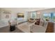 Sun-filled living area is decorated with modern furniture, a large screen TV and a view to the yard at 13113 Bayberry Way, Parrish, FL 34219