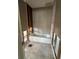 An unfinished bathroom shows the bathtub and wall studs awaiting remodeling at 13434 1St St E, Madeira Beach, FL 33708