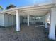 Charming carport with sturdy support columns and a convenient side entry door at 13434 1St St E, Madeira Beach, FL 33708