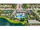 An aerial view showcases the pool, spa, clubhouse, tennis courts and manicured grounds within this luxury community at 13513 Deep Blue Pl, Bradenton, FL 34211