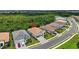 Aerial view of a home with a terra cotta roof, perfectly situated within a well-maintained neighborhood at 13513 Deep Blue Pl, Bradenton, FL 34211