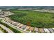 Expansive aerial view of the home set against a backdrop of lush greenery, lakes and planned community at 13513 Deep Blue Pl, Bradenton, FL 34211