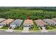 An aerial view of the home in a community surrounded by lush greenery at 13513 Deep Blue Pl, Bradenton, FL 34211