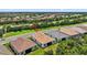 Scenic aerial view highlighting the home's location near a well-maintained road and beautiful landscaping at 13513 Deep Blue Pl, Bradenton, FL 34211