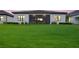 Lush backyard featuring a spacious lawn and screened in porch, great for entertaining at 13513 Deep Blue Pl, Bradenton, FL 34211