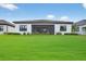 Well-manicured backyard with lush green grass and screened in patio, perfect for outdoor enjoyment at 13513 Deep Blue Pl, Bradenton, FL 34211