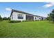 Expansive backyard with lush lawn and mature landscaping, including a screened in patio at 13513 Deep Blue Pl, Bradenton, FL 34211
