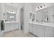 Well-lit bathroom with dual sinks, a modern vanity, and marble-look tile flooring at 13513 Deep Blue Pl, Bradenton, FL 34211