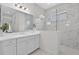 Bright bathroom features marble-look tile, a glass-enclosed shower, and a modern vanity with ample storage at 13513 Deep Blue Pl, Bradenton, FL 34211