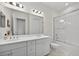 Bright bathroom with a bathtub shower combo, dual sink vanity, and modern fixtures at 13513 Deep Blue Pl, Bradenton, FL 34211