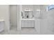 Elegant bathroom with marble tile, glass shower, and neutral vanity at 13513 Deep Blue Pl, Bradenton, FL 34211