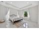 Tranquil bedroom features tray ceilings, natural light, and tile flooring at 13513 Deep Blue Pl, Bradenton, FL 34211