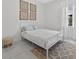 Bedroom with a white metal bed frame, white walls, and modern decor at 13513 Deep Blue Pl, Bradenton, FL 34211