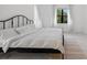 Cozy bedroom with a large window, tile flooring, and natural light at 13513 Deep Blue Pl, Bradenton, FL 34211