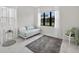 Bright bedroom with a daybed, marble-look tile flooring, and natural light at 13513 Deep Blue Pl, Bradenton, FL 34211