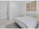 Bright bedroom with a white metal bed frame, a closet, and modern decor at 13513 Deep Blue Pl, Bradenton, FL 34211