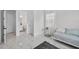 Bright bedroom with a daybed, marble-look tile flooring, and an ensuite bathroom at 13513 Deep Blue Pl, Bradenton, FL 34211