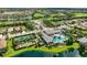 Aerial view of resort-style amenities including a pool, tennis courts, and clubhouse, enhancing community living at 13513 Deep Blue Pl, Bradenton, FL 34211