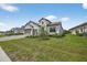Charming home with a well-maintained lawn, elegant landscaping, and a brick-paved driveway at 13513 Deep Blue Pl, Bradenton, FL 34211