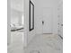 Hallway featuring white marble floors, a mirror, and views of the bedroom at 13513 Deep Blue Pl, Bradenton, FL 34211