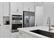 Modern kitchen featuring a stainless steel refrigerator and a white countertop at 13513 Deep Blue Pl, Bradenton, FL 34211