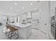 Bright kitchen featuring an island with bar seating, stainless appliances, and white cabinets at 13513 Deep Blue Pl, Bradenton, FL 34211