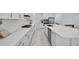 Modern kitchen with white countertops, cabinets, and stainless steel appliances at 13513 Deep Blue Pl, Bradenton, FL 34211