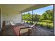 Covered patio with brick pavers, screened-in enclosure, and a view of the manicured backyard at 13513 Deep Blue Pl, Bradenton, FL 34211