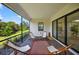 Relaxing screened-in patio featuring brick pavers, exterior view, and comfortable chairs at 13513 Deep Blue Pl, Bradenton, FL 34211