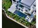 Aerial view showcases a modern home with a large pool, spa, and lush landscaping along the canal at 1610 N Lodge Dr, Sarasota, FL 34239