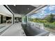 Balcony with jacuzzi, modern dining table, and seamless indoor-outdoor flow to kitchen, perfect for entertaining at 1610 N Lodge Dr, Sarasota, FL 34239