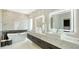 A luxurious bathroom boasting a soaking tub, marble countertops, LED-lit mirrors, and a modern vanity at 1610 N Lodge Dr, Sarasota, FL 34239