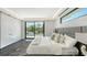 A luxurious bedroom featuring a king bed, expansive windows, and a serene outdoor view at 1610 N Lodge Dr, Sarasota, FL 34239