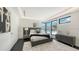 Modern bedroom featuring a gray padded headboard, decorative accents, and large windows for ample natural light at 1610 N Lodge Dr, Sarasota, FL 34239