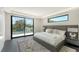 A luxurious bedroom featuring a king bed, expansive windows, and a serene outdoor view at 1610 N Lodge Dr, Sarasota, FL 34239