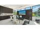 Contemporary dining area with a stylish table, modern seating, and a sleek built-in entertainment center at 1610 N Lodge Dr, Sarasota, FL 34239