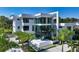 Modern home features clean lines, floor-to-ceiling windows, and lush landscaping for curb appeal at 1610 N Lodge Dr, Sarasota, FL 34239