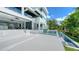 Stunning modern home exterior with a pool, sleek white finishes, and lush tropical landscaping, creating a serene oasis at 1610 N Lodge Dr, Sarasota, FL 34239